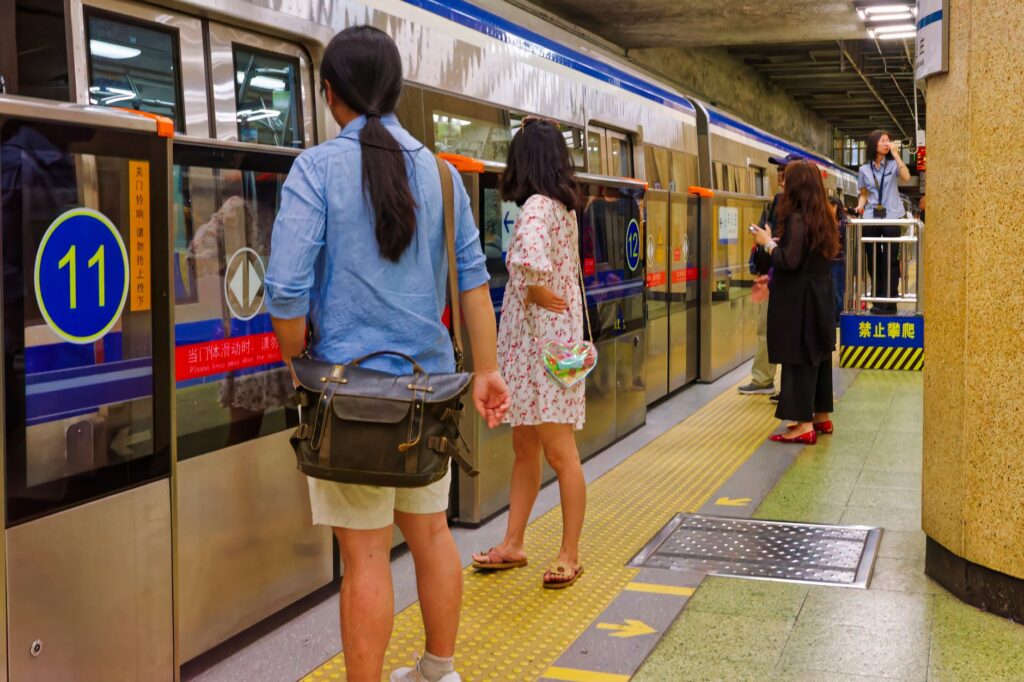 Passengers waiting at the platform doors of a Beijing subway train