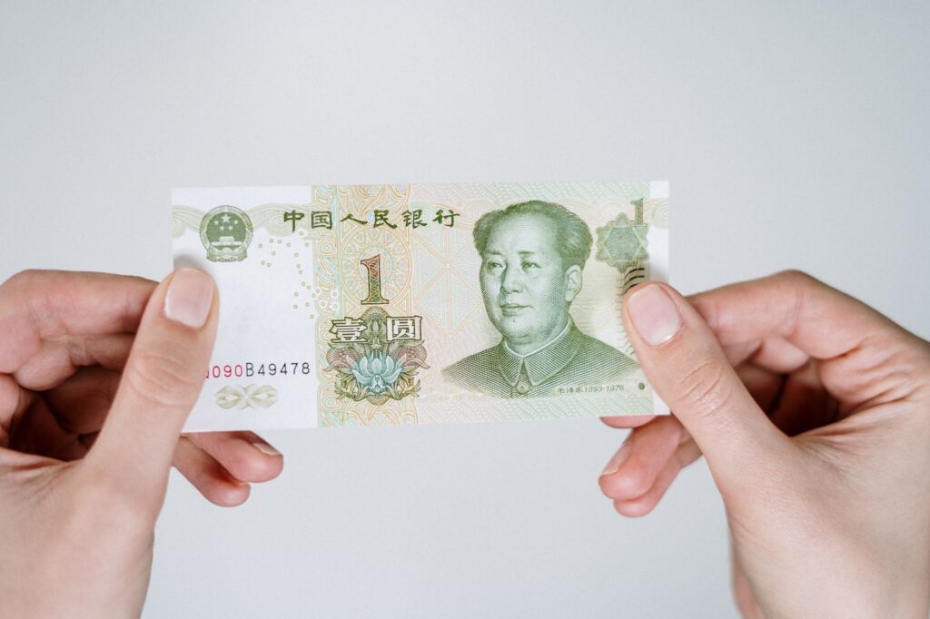 Hands holding a one-yuan Chinese banknote
