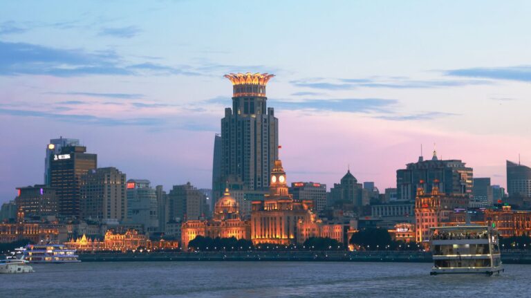The Bund in Shanghai at dusk, with lit historic buildings along the Huangpu River